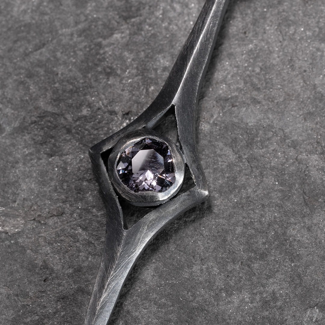 collier en argent avec un pendentif en argent sculpté avec un spinelle gris mauve.