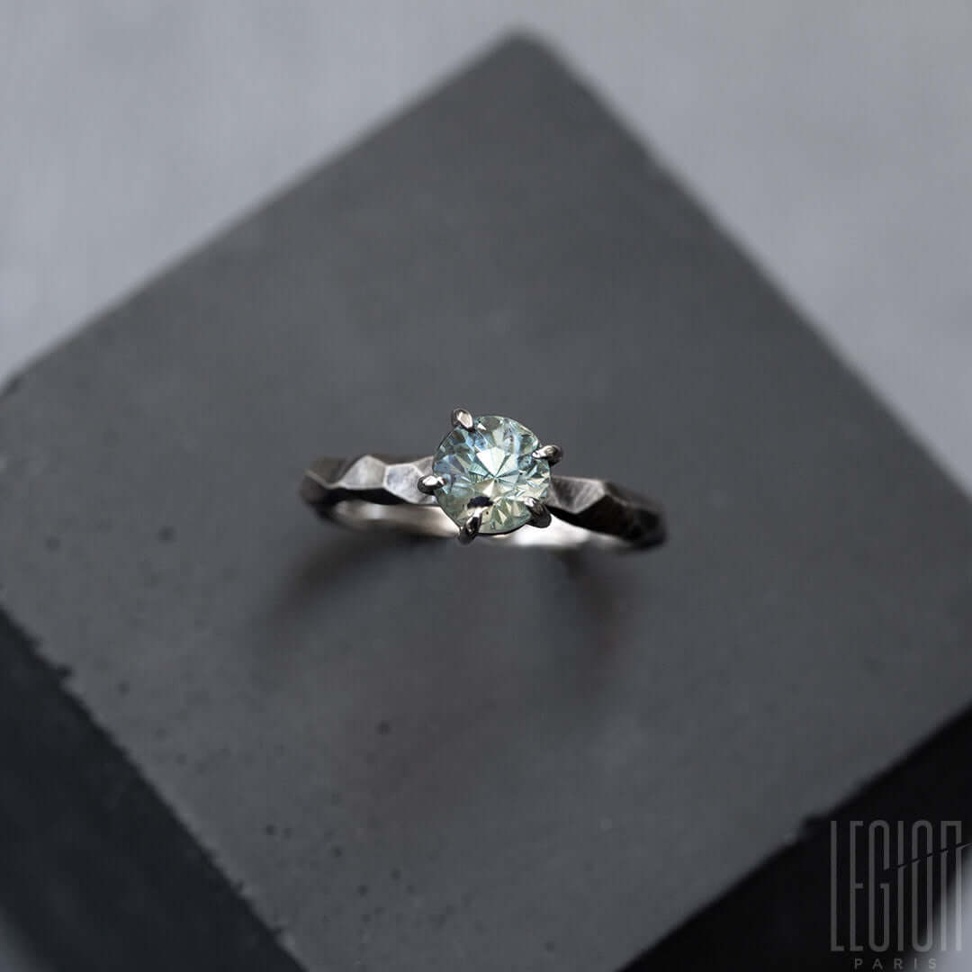 bague solitaire en or blanc texturée avec une pierre aigue marine bleue
