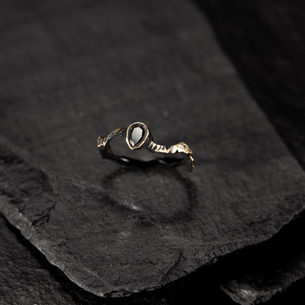 fine textured ring in blackened yellow gold and pear-shaped black diamond