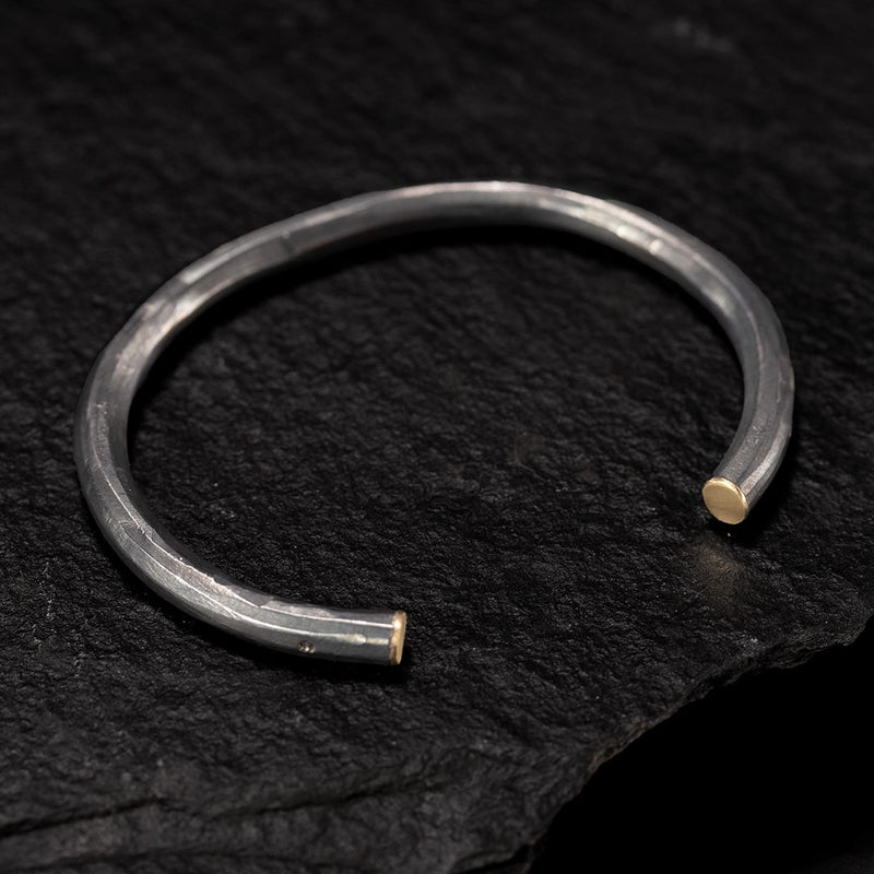 black silver and yellow gold bangle