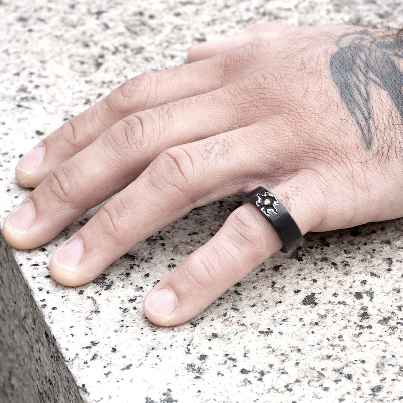 Black silver ring with a garnet in the center