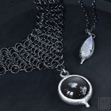 pair of black silver necklaces with moon stones