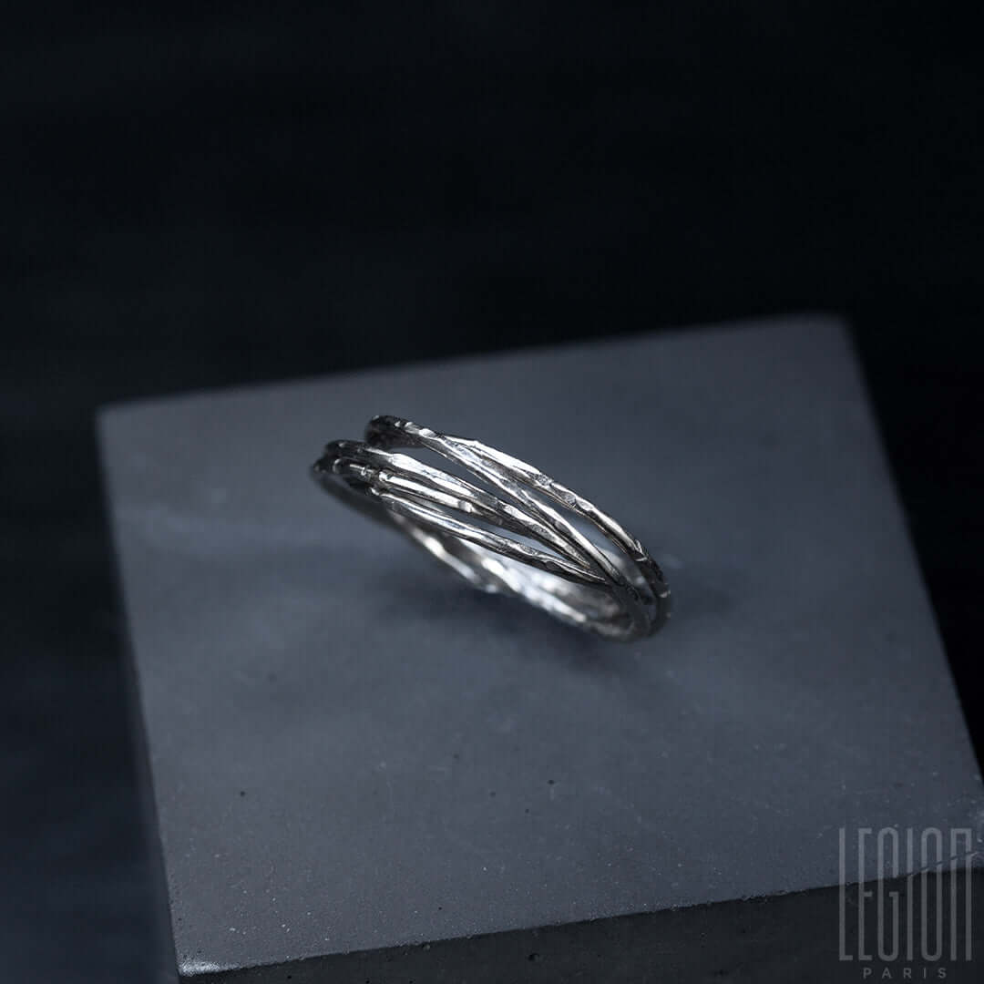 vue de côté d'une bague Legion Paris en or blanc 750 composée de 5 anneaux martelés et entrelacés